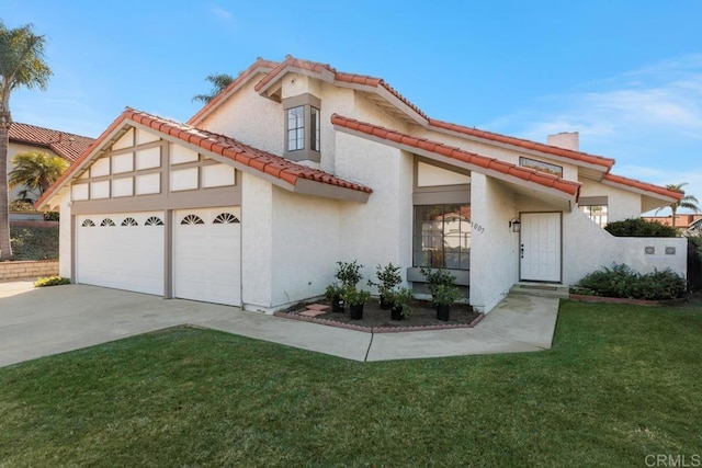 mediterranean / spanish home featuring a garage and a front yard