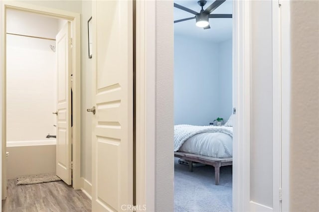 hallway with light hardwood / wood-style floors