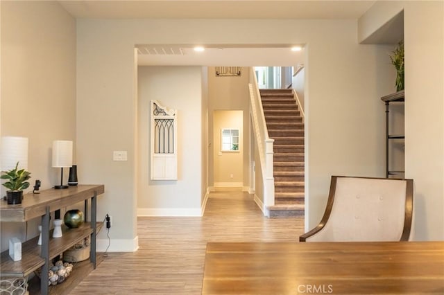 corridor with light hardwood / wood-style flooring