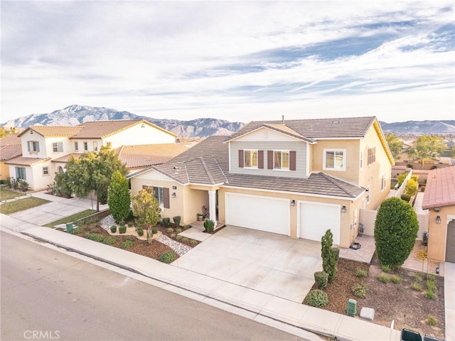 view of property featuring a garage and a mountain view