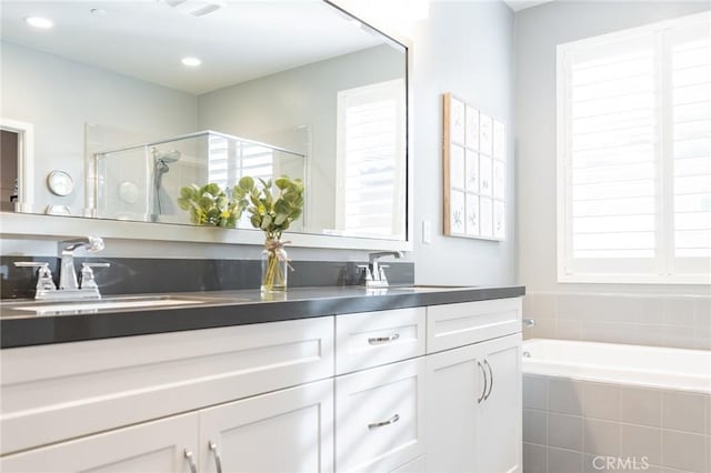 bathroom featuring vanity and separate shower and tub