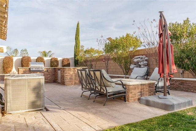 view of patio / terrace with central AC unit, grilling area, and an outdoor kitchen