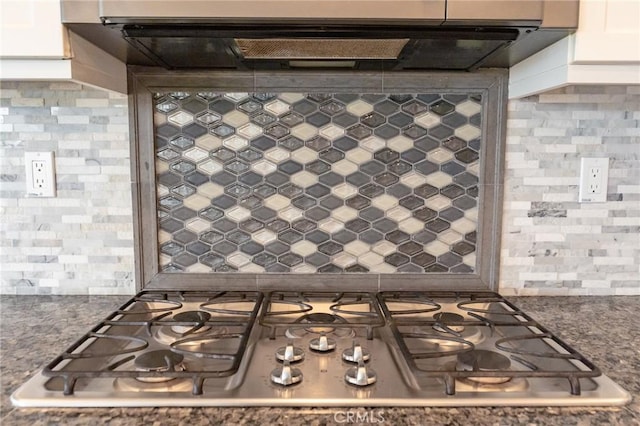 kitchen with stainless steel gas stovetop, extractor fan, backsplash, and white cabinetry