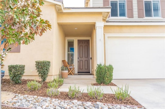 view of exterior entry featuring a garage