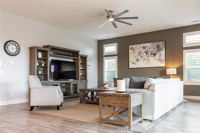 living room with ceiling fan and light hardwood / wood-style floors