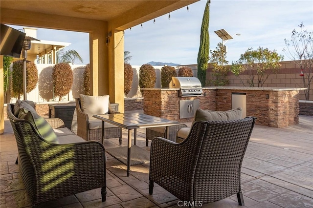 view of patio / terrace with a mountain view, area for grilling, and grilling area