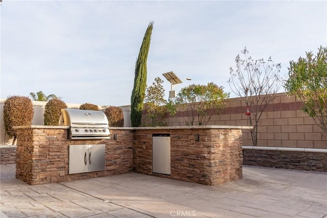 view of patio with exterior kitchen and grilling area