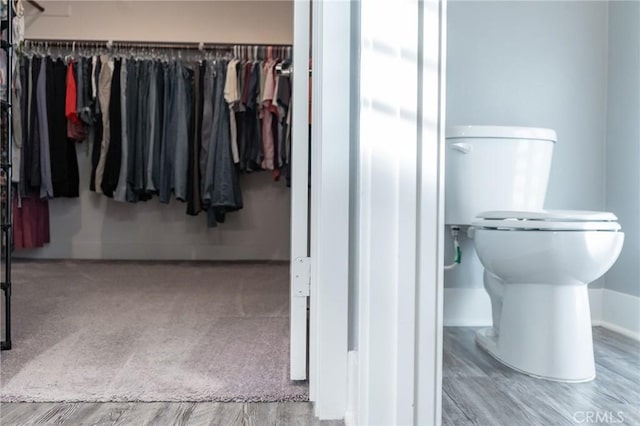 bathroom with hardwood / wood-style flooring and toilet