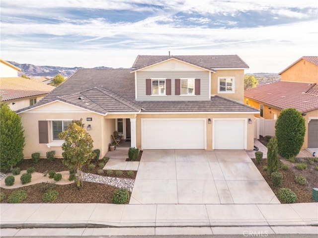 view of property featuring a garage and a mountain view