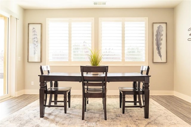 dining area featuring plenty of natural light and light hardwood / wood-style floors