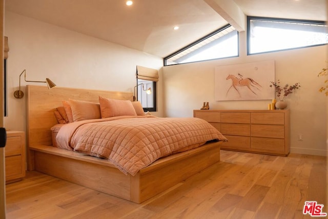 bedroom featuring light hardwood / wood-style floors and lofted ceiling with beams