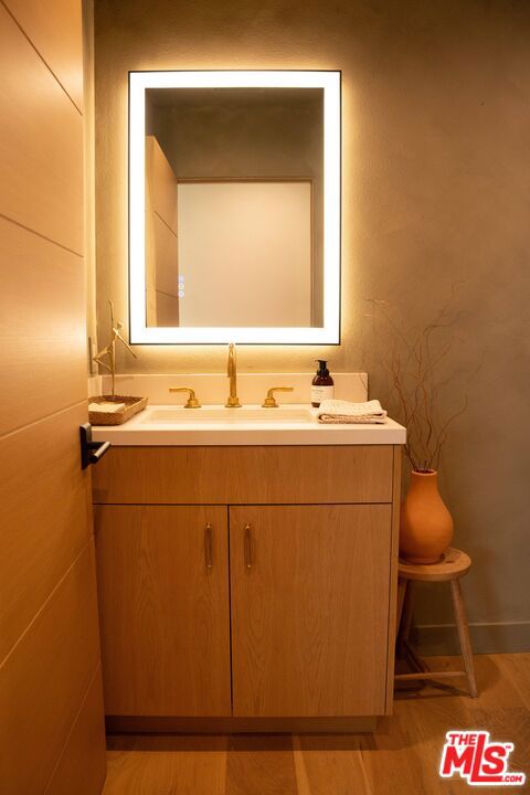 bathroom with vanity and hardwood / wood-style floors