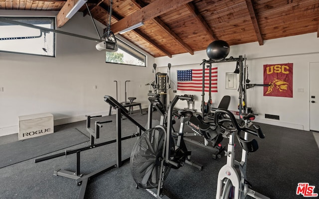 exercise room featuring vaulted ceiling and wood ceiling