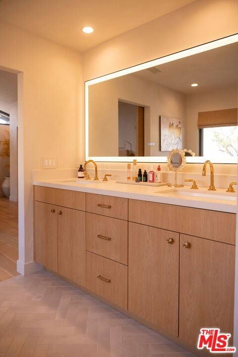 bathroom with parquet floors and vanity