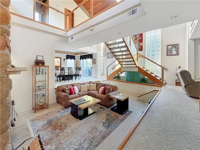 interior space with stairs, a high ceiling, and visible vents