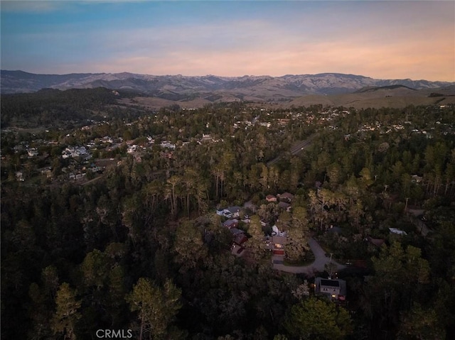 aerial view at dusk featuring a mountain view