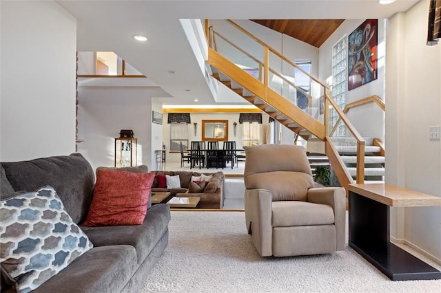 carpeted living room with recessed lighting, wood ceiling, stairway, and a high ceiling