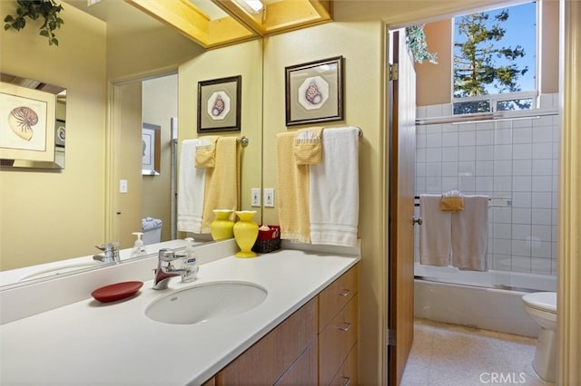 bathroom with shower / bath combination with glass door, vanity, and toilet