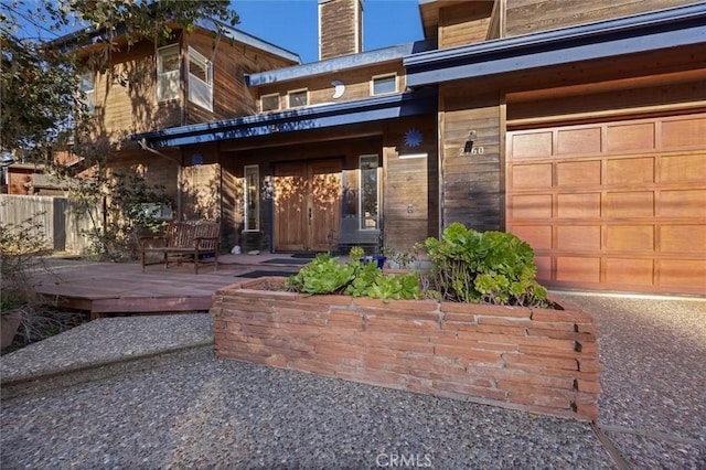 property entrance featuring a garage and fence