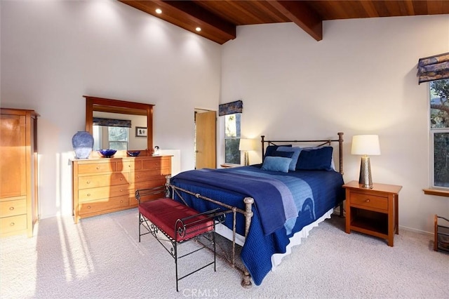 bedroom featuring light carpet, high vaulted ceiling, and beamed ceiling