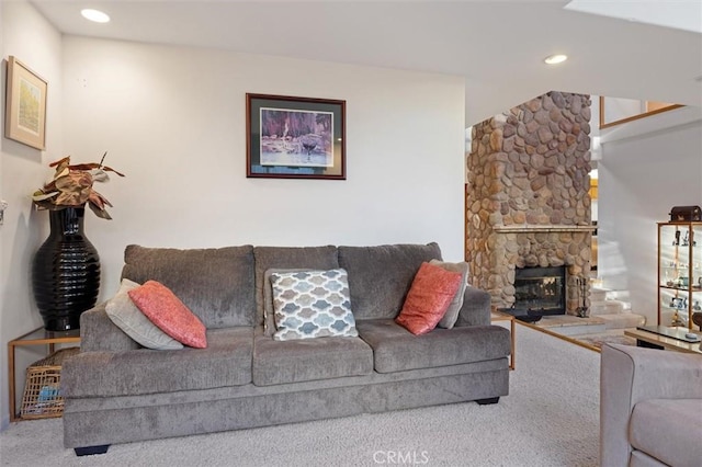 living room with carpet, recessed lighting, and a stone fireplace