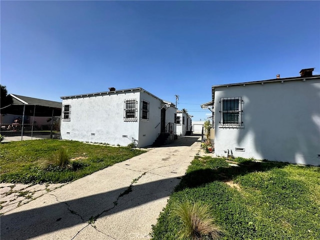 view of property exterior with a yard