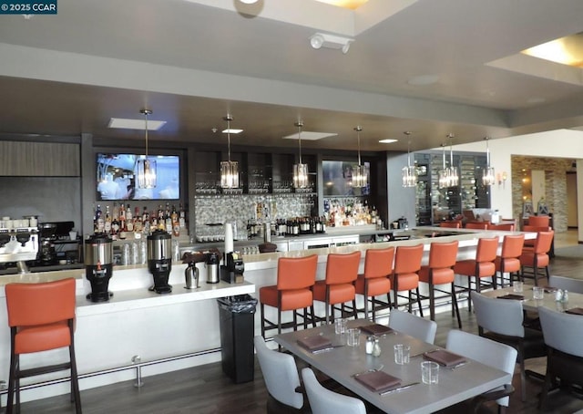 bar featuring dark wood-type flooring and pendant lighting