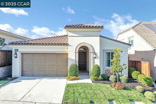 mediterranean / spanish-style home featuring a garage and a front yard