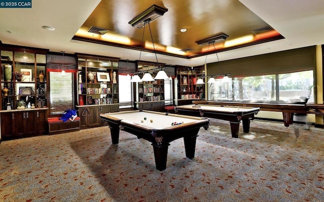 game room with a raised ceiling, light colored carpet, and pool table