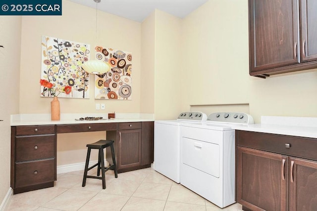 clothes washing area with cabinets, separate washer and dryer, and light tile patterned floors