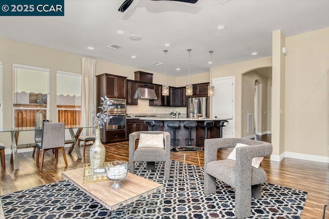 living room featuring ceiling fan and light wood-type flooring