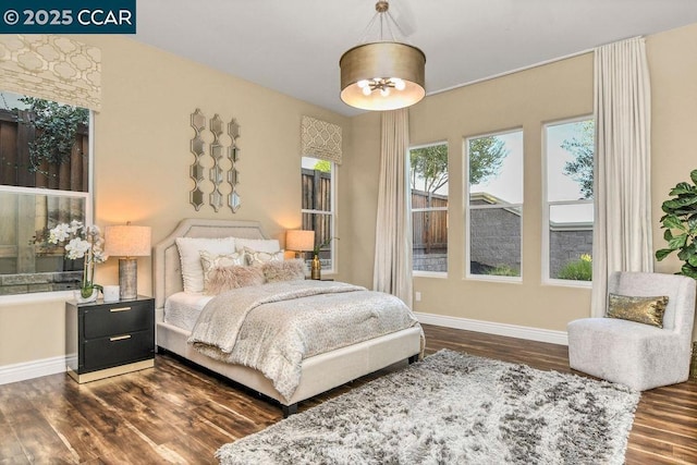 bedroom with dark hardwood / wood-style flooring