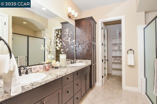 bathroom featuring vanity, tile patterned flooring, and a shower with door