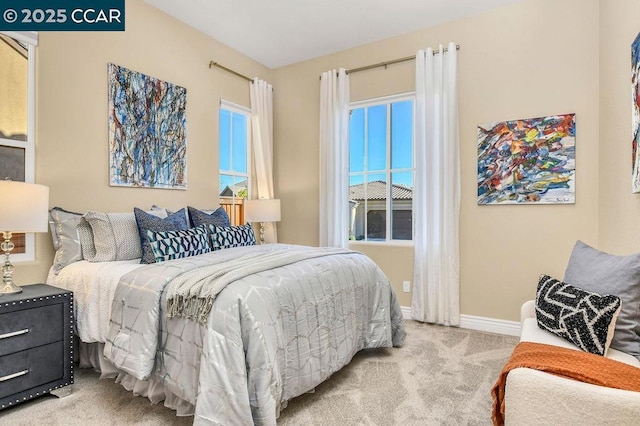 bedroom featuring light carpet