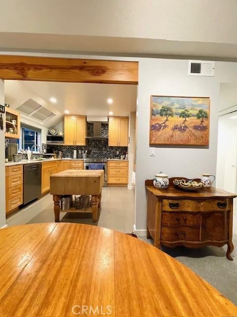 kitchen with black dishwasher, tasteful backsplash, stainless steel range, light brown cabinetry, and wall chimney exhaust hood