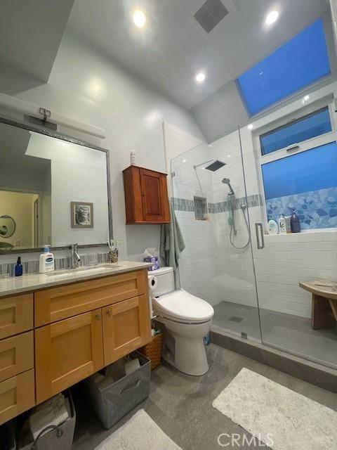 bathroom with vanity, toilet, and walk in shower