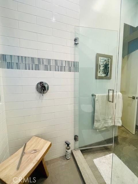 bathroom with concrete flooring and an enclosed shower