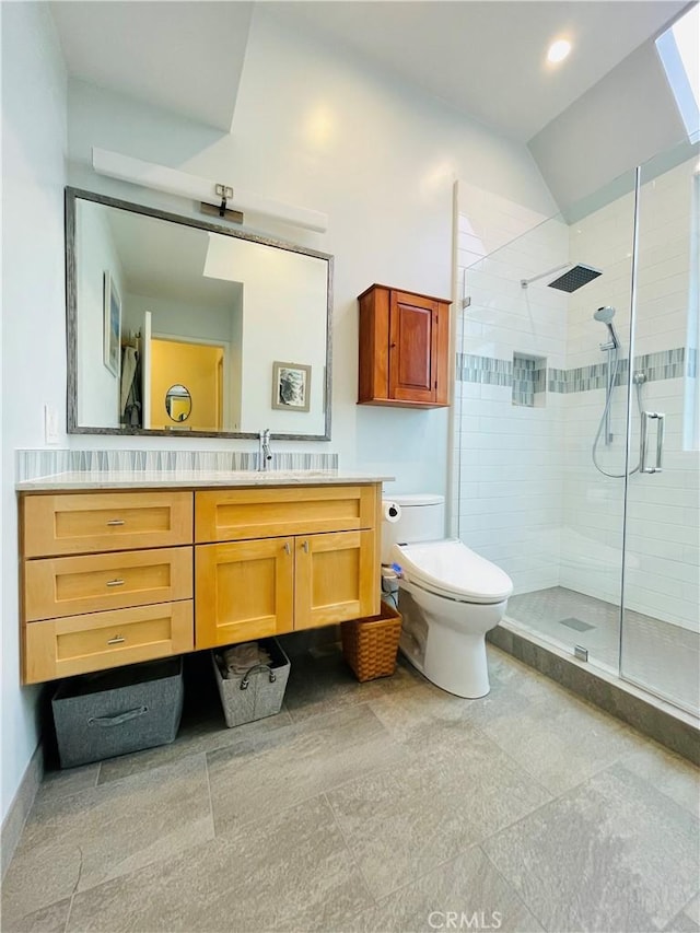 bathroom with walk in shower, lofted ceiling, vanity, and toilet