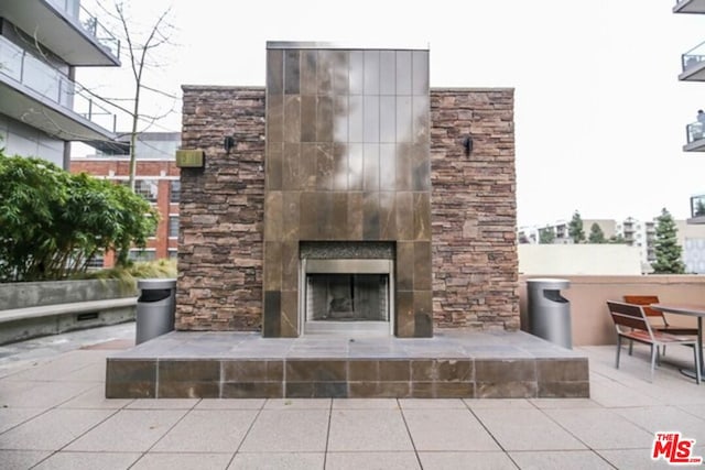 view of patio featuring a fireplace