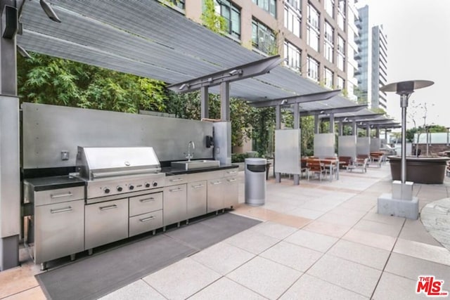 view of patio featuring area for grilling, a pergola, and sink