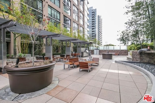 view of community with a patio and a fire pit