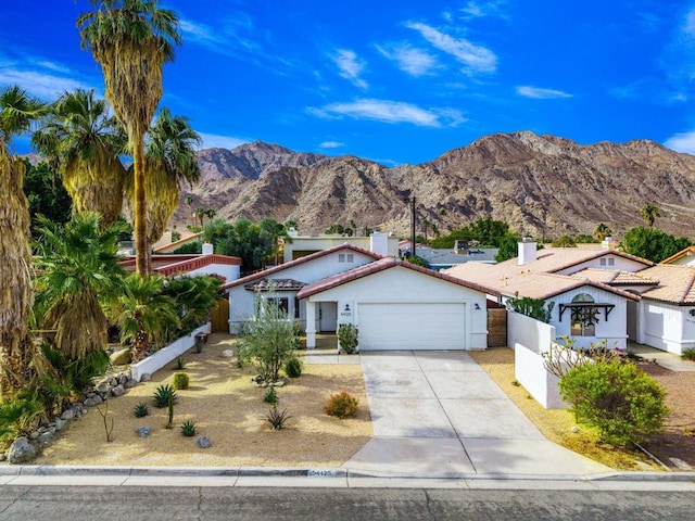 view of front of house featuring a garage and a mountain view