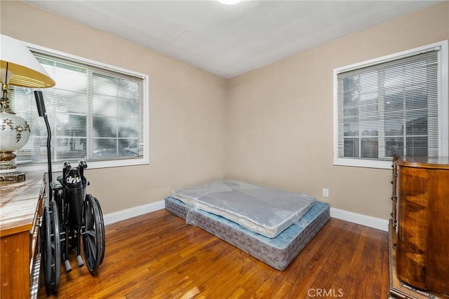 bedroom with dark wood-type flooring