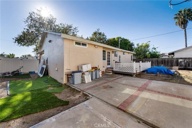 back of property with a patio and a yard