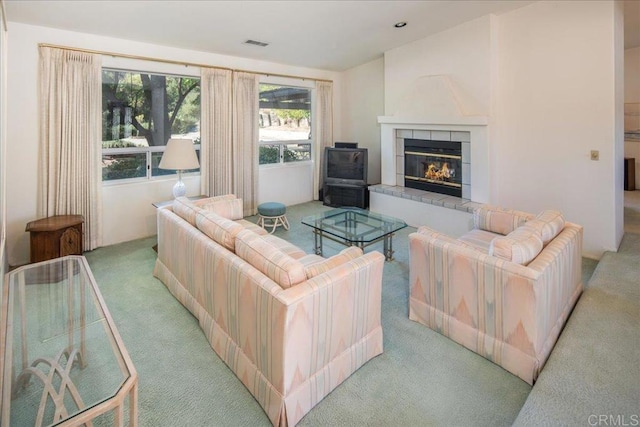 living room with light carpet and a fireplace