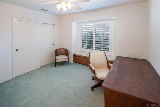 carpeted home office with ceiling fan