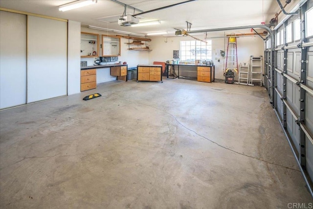 garage with a garage door opener and a workshop area