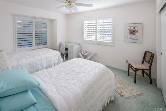 bedroom featuring light carpet and ceiling fan