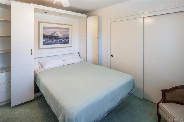 carpeted bedroom with ceiling fan and a closet