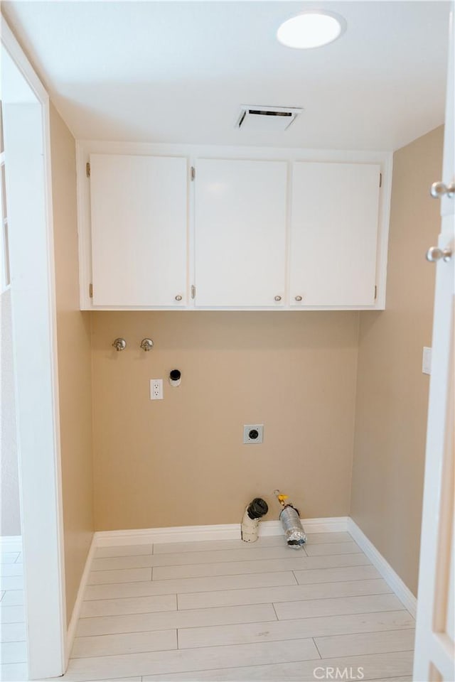 laundry area featuring cabinets, washer hookup, hookup for an electric dryer, and light wood-type flooring